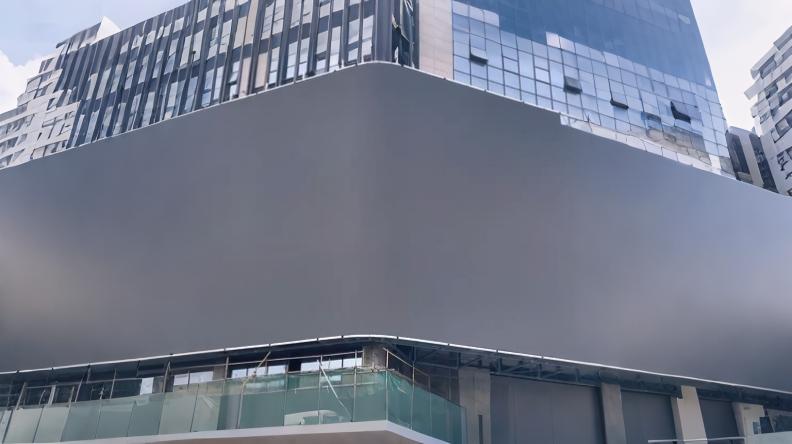 Installation of a 1,000m² outdoor 3D curved corner LED screen delivering immersive naked-eye 3D visual effects in urban advertising.