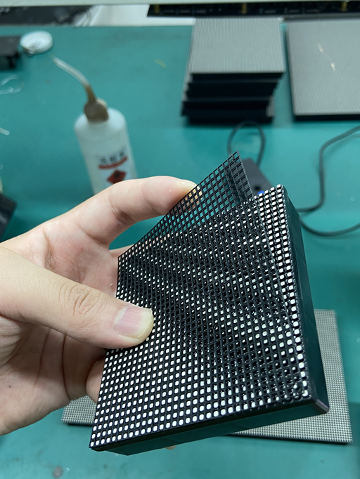 Close-up of LED display module with a black mask covering LED beads to enhance contrast and protect the lights.